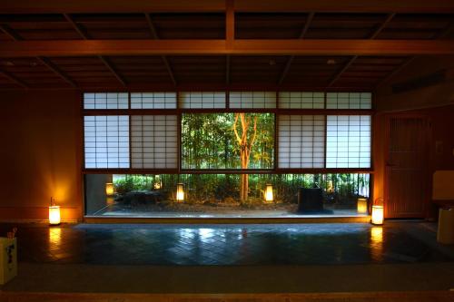 a room with a large window with lights in it at Sansuirou in Yugawara