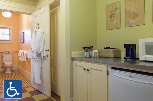 a bathroom with a sink and a toilet and a microwave at Tallman Hotel in Upper Lake