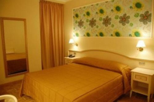 a hotel room with a bed and a painting on the wall at Relais Villa Fornari in Camerino