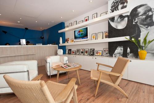 a living room with chairs and a table at Hotel Victoria in Roquebrune-Cap-Martin