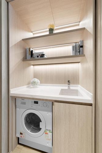 a kitchen with a washing machine and a sink at ALVA HOTEL BY ROYAL in Hong Kong