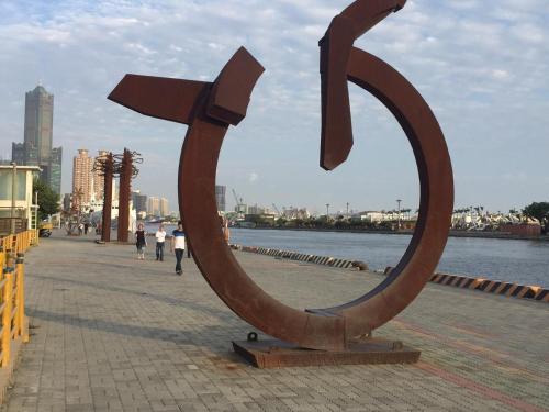 a large sculpture of a dollar sign on a sidewalk at Wenpin Hotel - Pier 2 in Kaohsiung