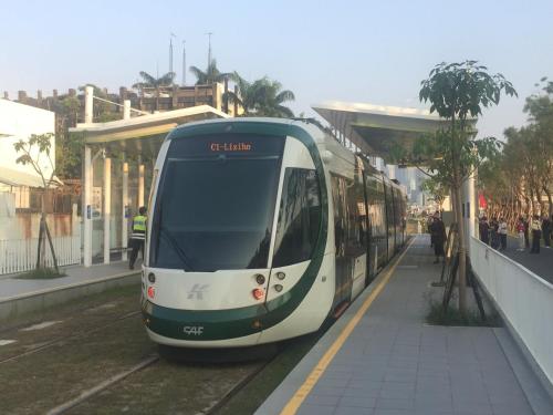 a white and green tram at a train station at Wenpin Hotel - Pier 2 in Kaohsiung