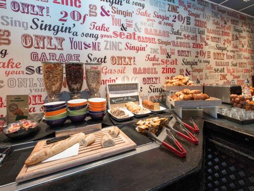 a buffet line with different types of food on display at ibis Styles Chartres Métropole in Chartres
