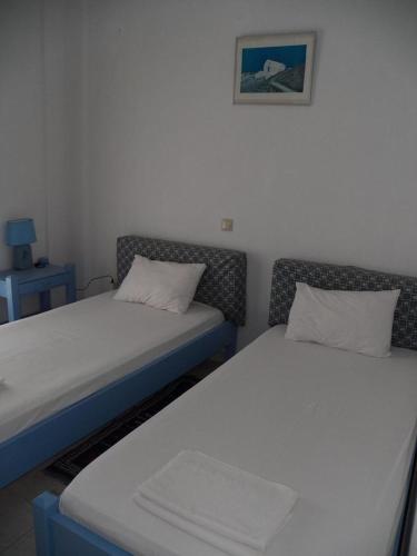 a room with two beds and a table with a picture at Villa Marina in Ipsos