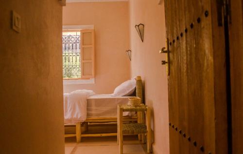 a bedroom with a bed and a window at Dar Ajgal in Dourtane