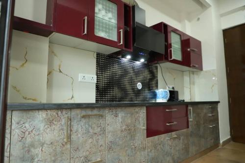 a kitchen with red cabinets in a room at Excellent Property With Exellent Amenities You Would Love To Live In in Rishīkesh