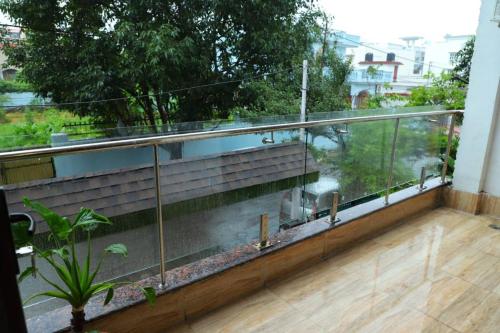 a balcony with a view of a garden at Excellent Property With Exellent Amenities You Would Love To Live In in Rishīkesh