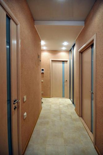 an empty hallway with doors and a tile floor at Naykova district Apartments in Kharkiv