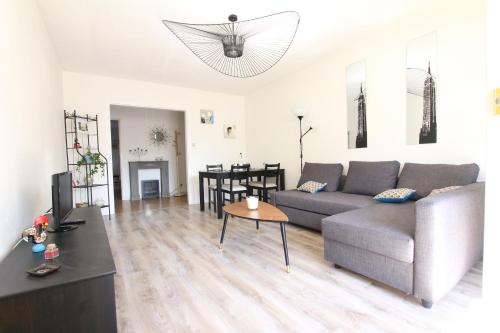 a living room with a couch and a table at Colmar City Center - SCHNAPSALA Terrasse and Free Parking - BookingAlsace in Colmar