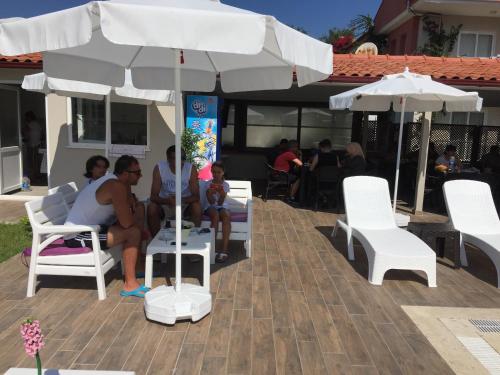 a group of people sitting in chairs under an umbrella at Vespera hotel in Dalyan