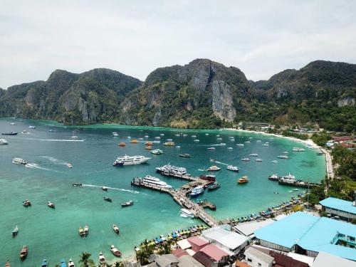 un groupe de bateaux dans l'eau d'un port dans l'établissement Natacha Hotel, sur les Îles Phi Phi