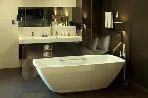 a bathroom with a white sink and a mirror at Liberty Central Saigon Citypoint in Ho Chi Minh City