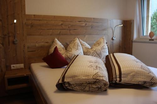 a bedroom with a bed with pillows on it at Alpenapart Hochzeiger in Jerzens
