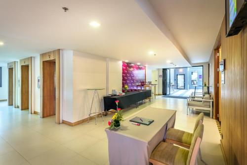 a large living room with a table and chairs at PLAAI Prime Hotel Rayong SHA Extra Plus in Rayong