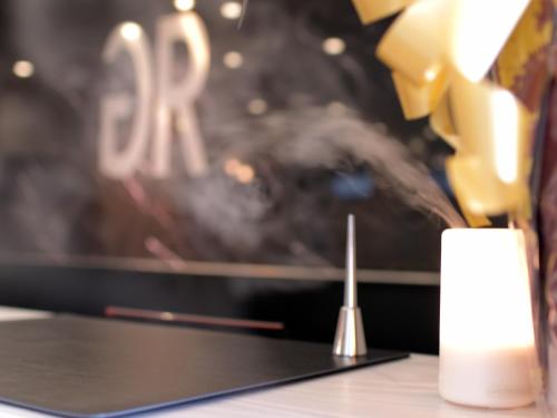 a close up of a candle on a table at Green Rich Hotel Tottori Ekimae (Artificial hot spring Futamata Yunohana) in Tottori