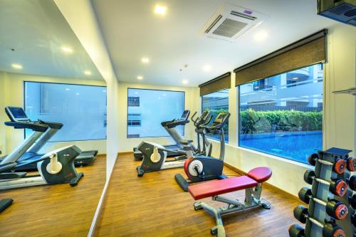 a gym with treadmills and ellipticals in a building at PLAAI Prime Hotel Rayong SHA Extra Plus in Rayong
