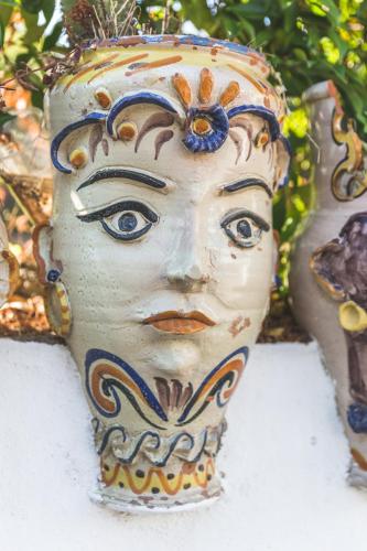 a vase with a face painted on it at Villa dei Sogni in Vulcano