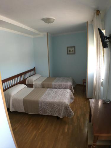 Postel nebo postele na pokoji v ubytování Hostal ** EC León