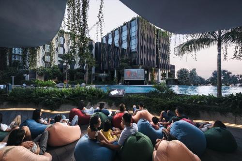a group of people sitting on bean bags in front of a building at Village Hotel Sentosa by Far East Hospitality in Singapore