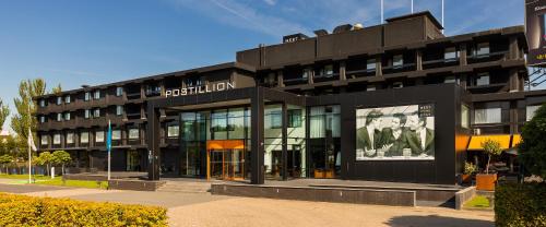 a black building with a sign on the front of it at Postillion Hotel Dordrecht in Dordrecht