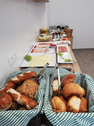 a table with two baskets of different types of bread at Hotel Garni Fischerfleck in Ismaning near Munich in Ismaning