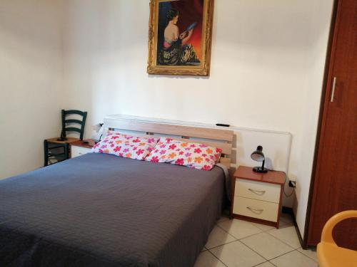 a bedroom with a bed and a picture on the wall at Terrazzo su Ibla in Ragusa