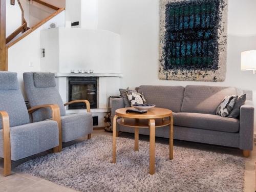 a living room with two couches and a coffee table at Holiday Home Aida by Interhome in Tahkovuori