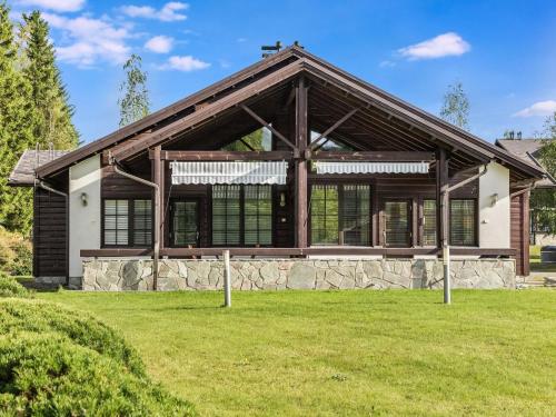a large house with a gambrel roof at Holiday Home Aida by Interhome in Tahkovuori