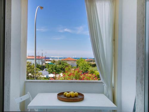 a bowl of fruit on a table in front of a window at Apartment Sandra by Interhome in Le Focette