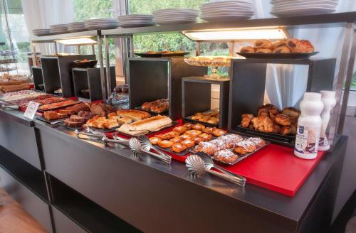 a buffet with many different types of pastries and other foods at Hotel Playa Ribera in Suances