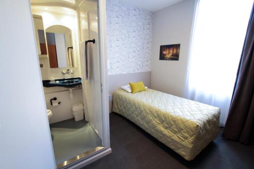 a small bedroom with a bed and a mirror at Centre Jean Bosco in Lyon