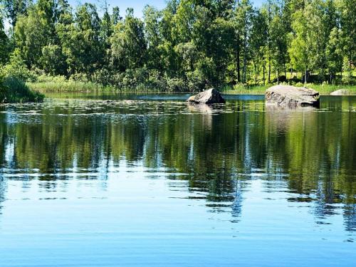 a lake with two rocks in the middle of it at 4 person holiday home in STUREFORS in Sturefors