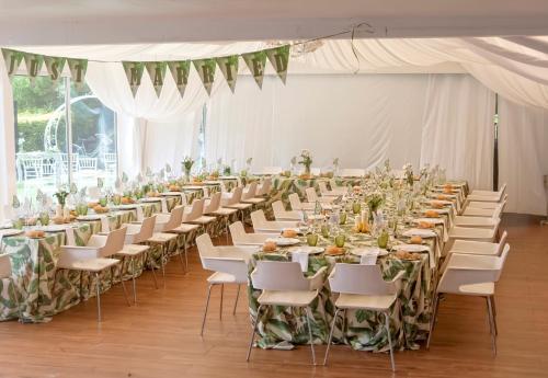a row of tables and chairs in a white tent at Hotel Playa Ribera in Suances