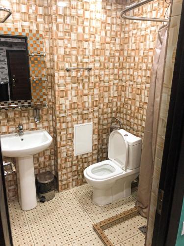 a bathroom with a toilet and a sink at Hotel Victoria in Yerevan
