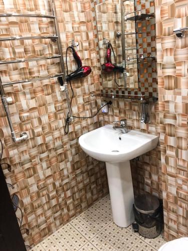 a bathroom with a sink and a shower with a mirror at Hotel Victoria in Yerevan