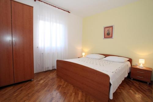 Posteľ alebo postele v izbe v ubytovaní Apartmani Radan
