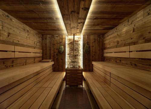 an empty sauna with wooden floors and wooden walls at Wellness Hotel Astra in Špindlerův Mlýn
