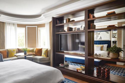 a bedroom with a bed and a living room at The Cadogan, A Belmond Hotel, London in London