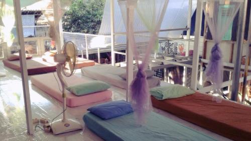 a room with several beds on a balcony at Yez Yez Yez All Good Hostel in Yogyakarta