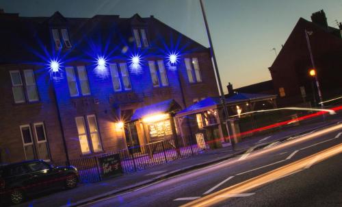 a building with blue lights on the side of it at The Portland in Ashington