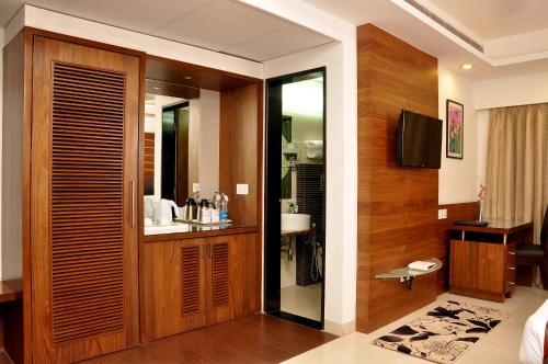 a bathroom with a wooden door with a sink at Hotel Niharika in Kolkata