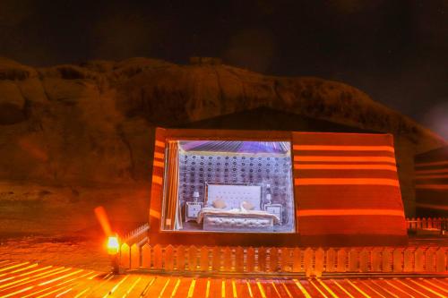 a stage with a display of a bed in the desert at Discover the life of Wadi Rum in Wadi Rum