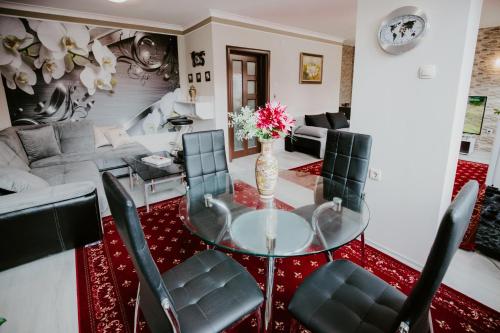 a living room with a glass table and chairs at Dimitrovi Rooms in Sofia
