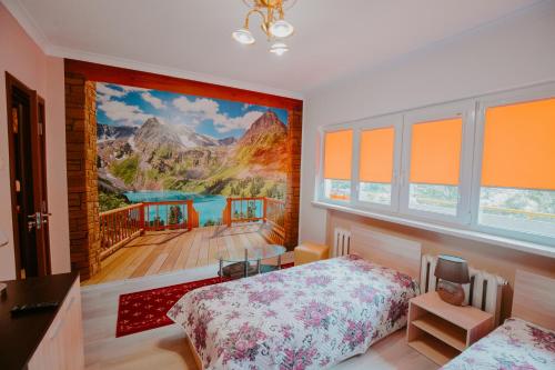 a bedroom with a large painting on the wall at Dimitrovi Rooms in Sofia