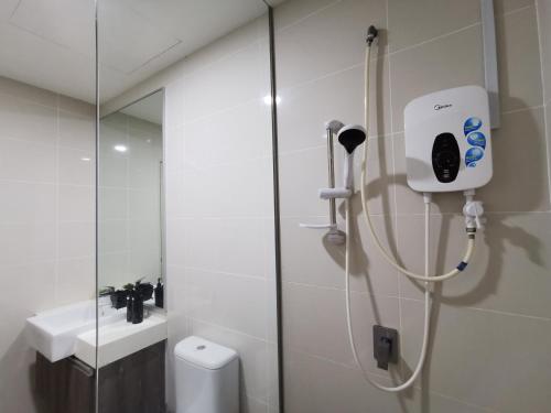 a shower in a bathroom with a toilet and a sink at Mid Valley Southkey Mosaic Cozy Suite at Johor Bahru in Johor Bahru