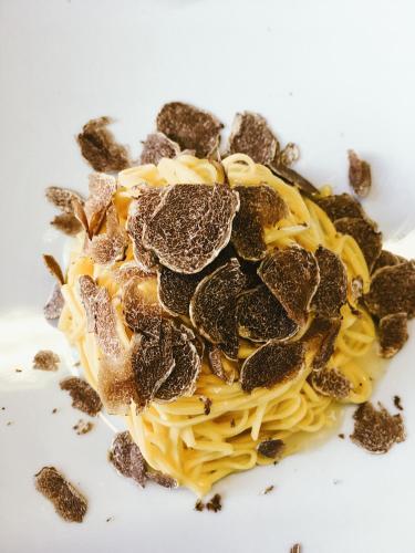 a plate of pasta with nuts on top at Vinoteca La Sacrestia in Alba