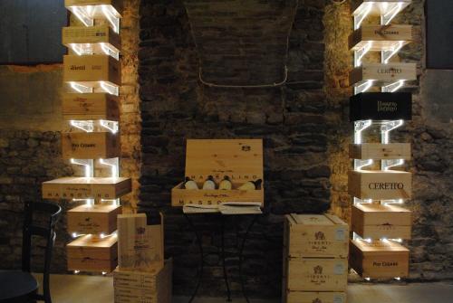 a bunch of boxes in a room with lights at Vinoteca La Sacrestia in Alba