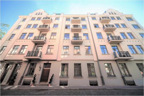a pink building with windows and balconies at Rixwell Old Riga Palace Hotel in Rīga