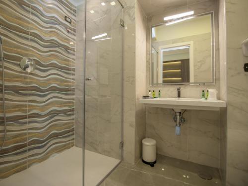 a bathroom with a shower and a sink at Hotel San Pietro in Naples